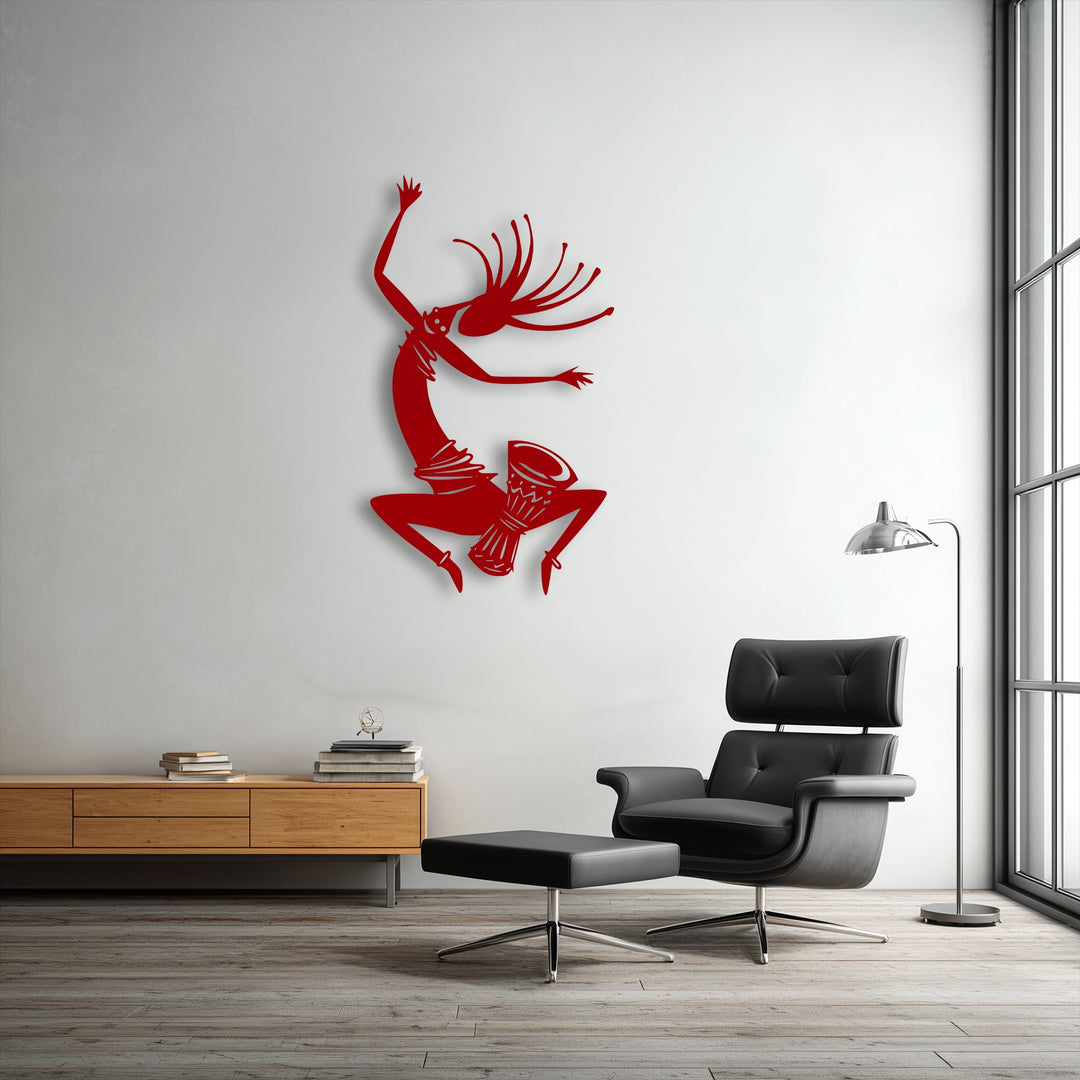 Soft, diffused light highlights the dynamic shadows cast by the unique metal wall art depicting a tribal dance silhouette.