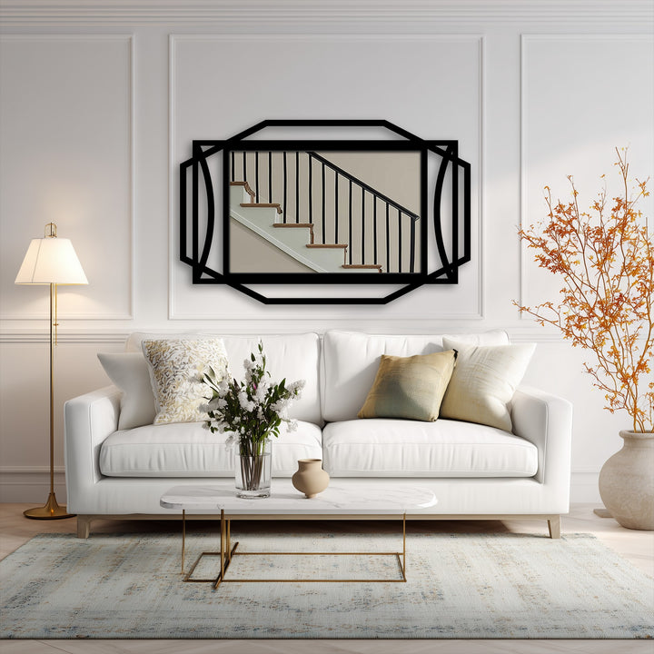 Focusing on the focal point, the geometric black metal artwork frames an abstract stairwell image, providing a modern art deco look.
