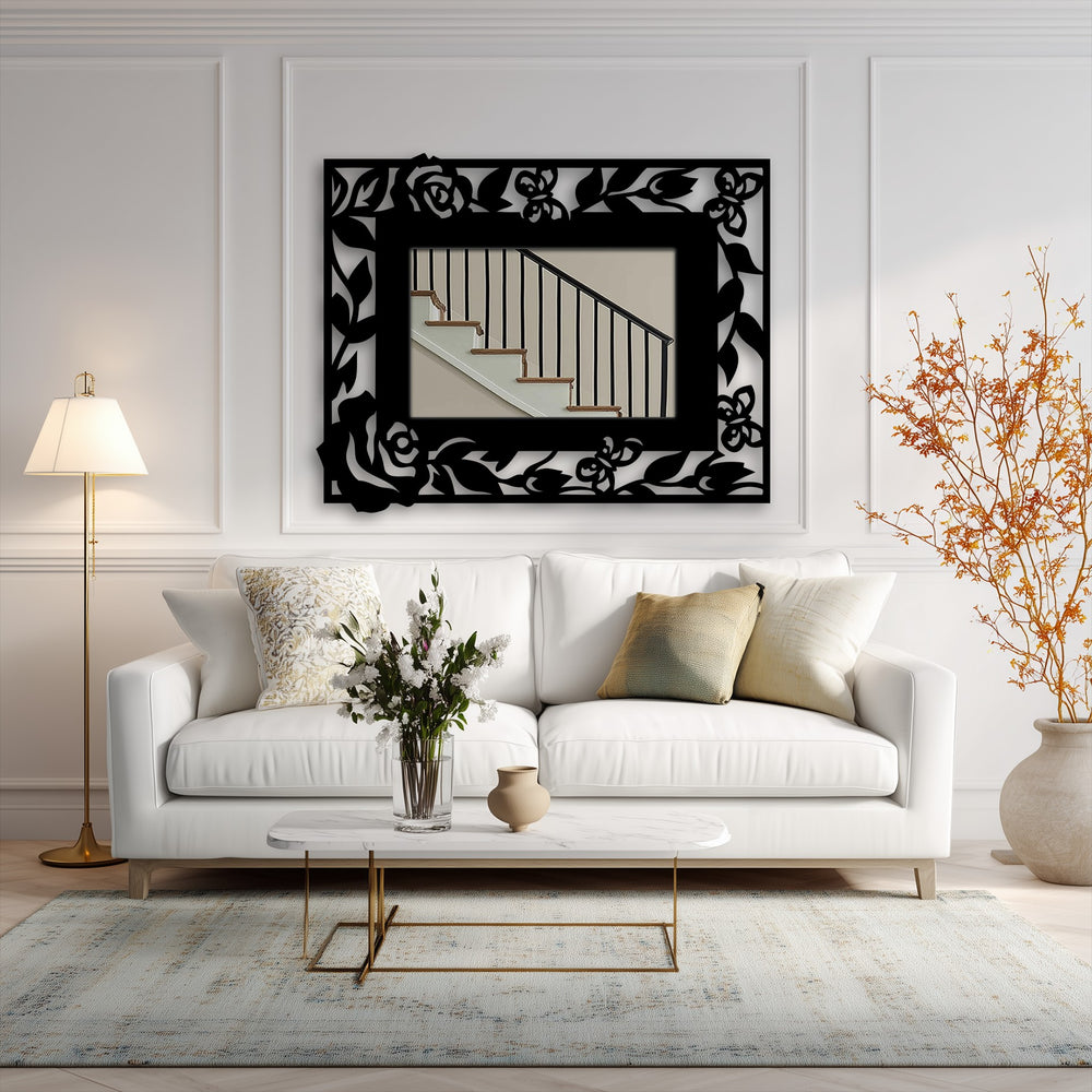 The foreground shows a marble-topped coffee table with flowers, set before a white couch and a decorative metal art floral butterfly frame mirror.