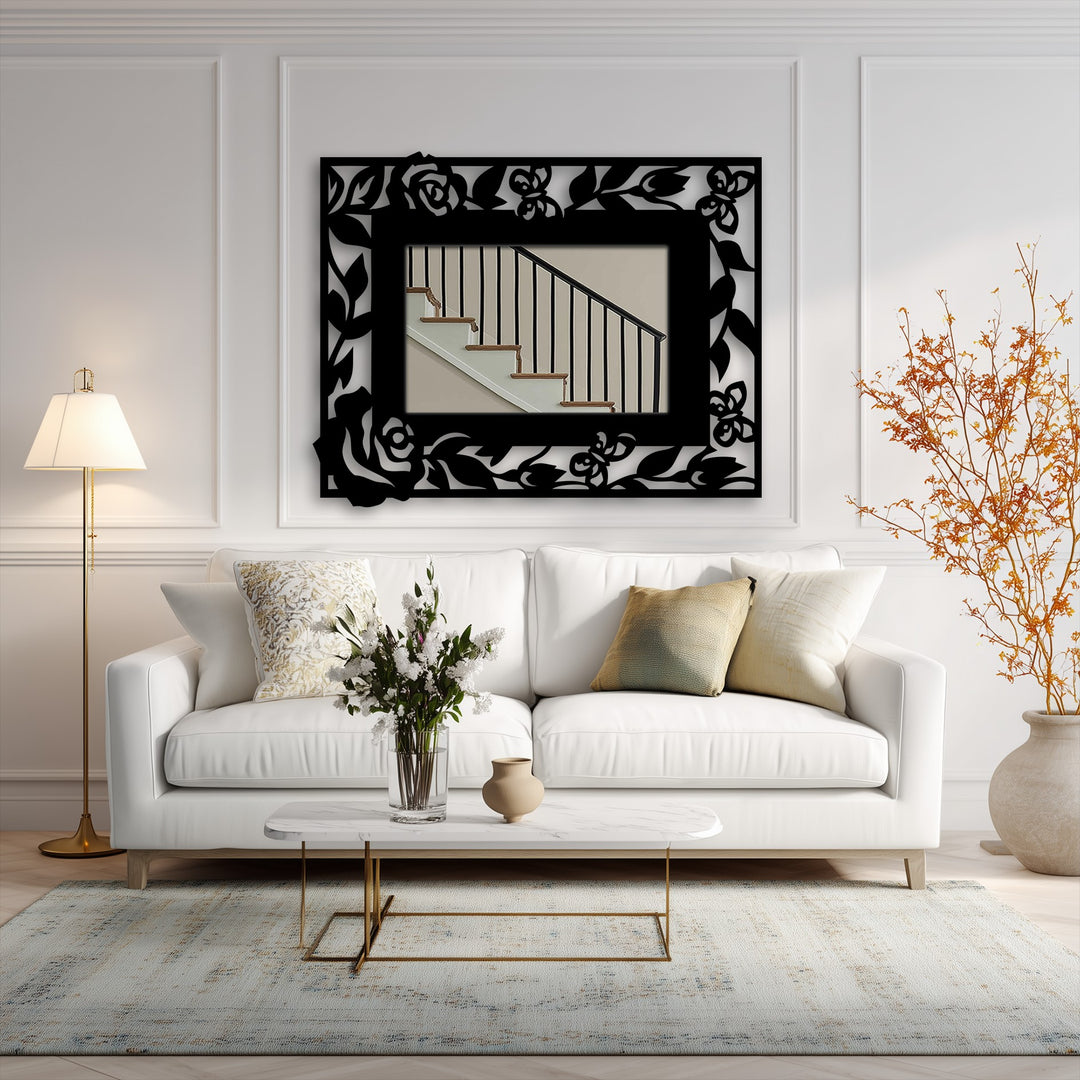 The foreground shows a marble-topped coffee table with flowers, set before a white couch and a decorative metal art floral butterfly frame mirror.