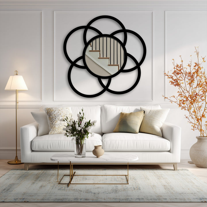 Vertically oriented, circular framed wall mirror features an interlocked circle design, showcasing a striking piece of framed wall mirror.