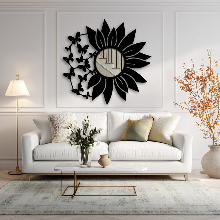 Showcasing the abstract quality, a modern butterfly bloom floor mirror for wall decor is framed by a black floral metal design, reflecting a stairway within its circular center.