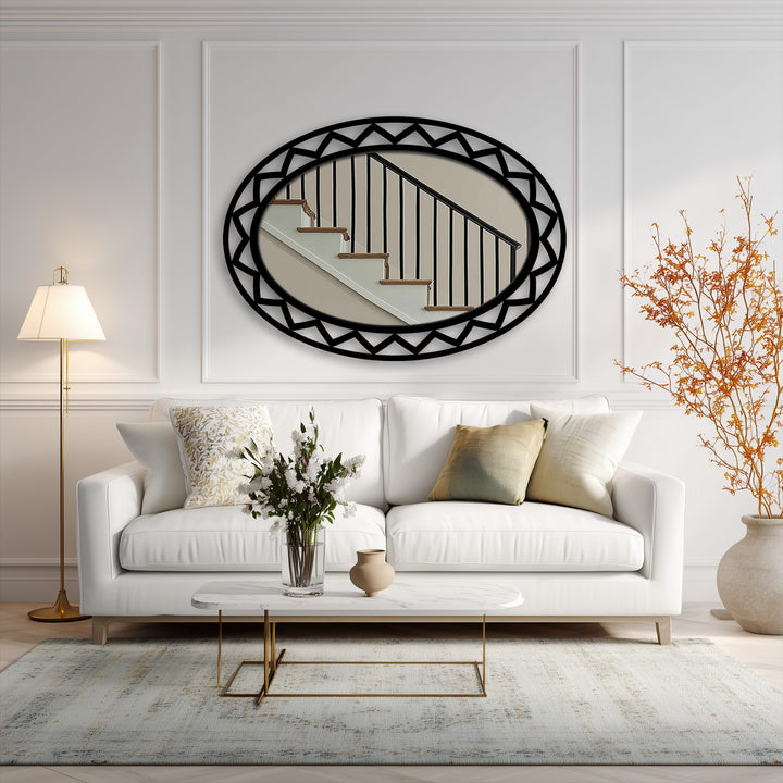 Sharp color contrast defines this decorative mirror, with its black geometric frame reflecting an interior scene in stark opposition to the bright white surrounding space.