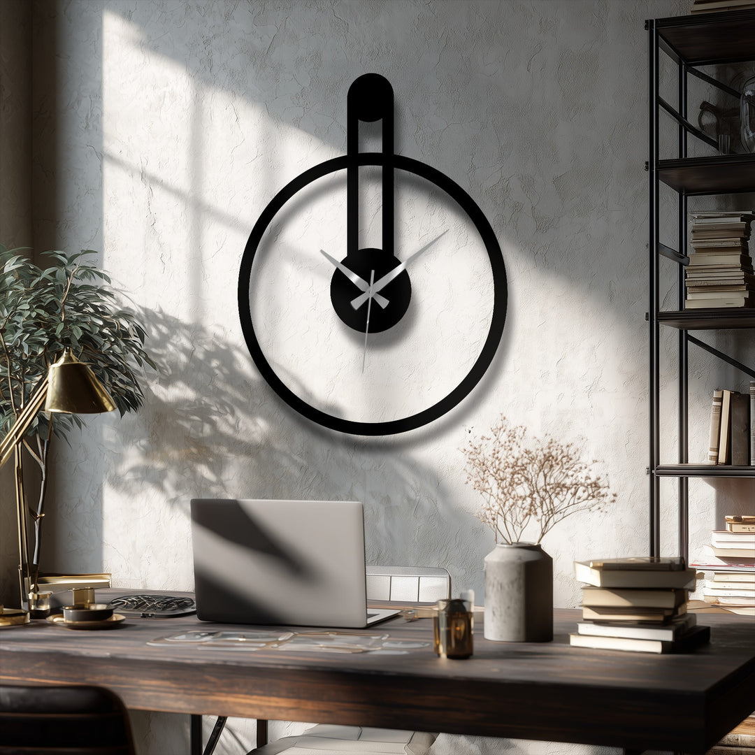 Dramatic color contrast highlights the minimalist black metal artwork of this round wall clock featuring a modern vertical accent.