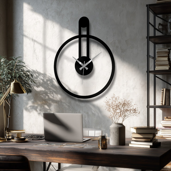 Dramatic color contrast highlights the minimalist black metal artwork of this round wall clock featuring a modern vertical accent.