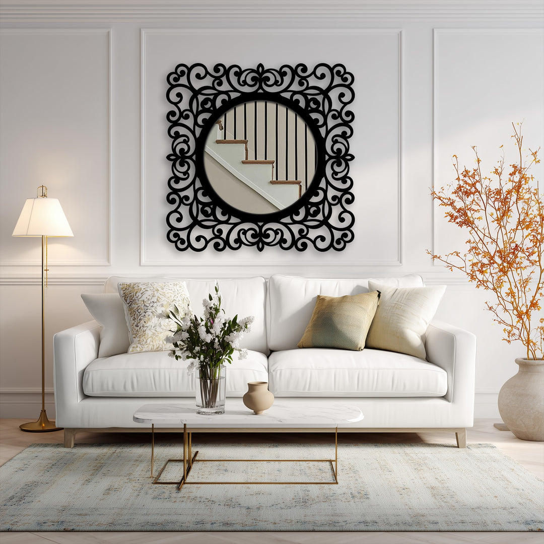 Seen in the background, the staircase reflection and paneled wall add depth behind the baroque scroll frame, complementing the unique metal wall art of the mirror.