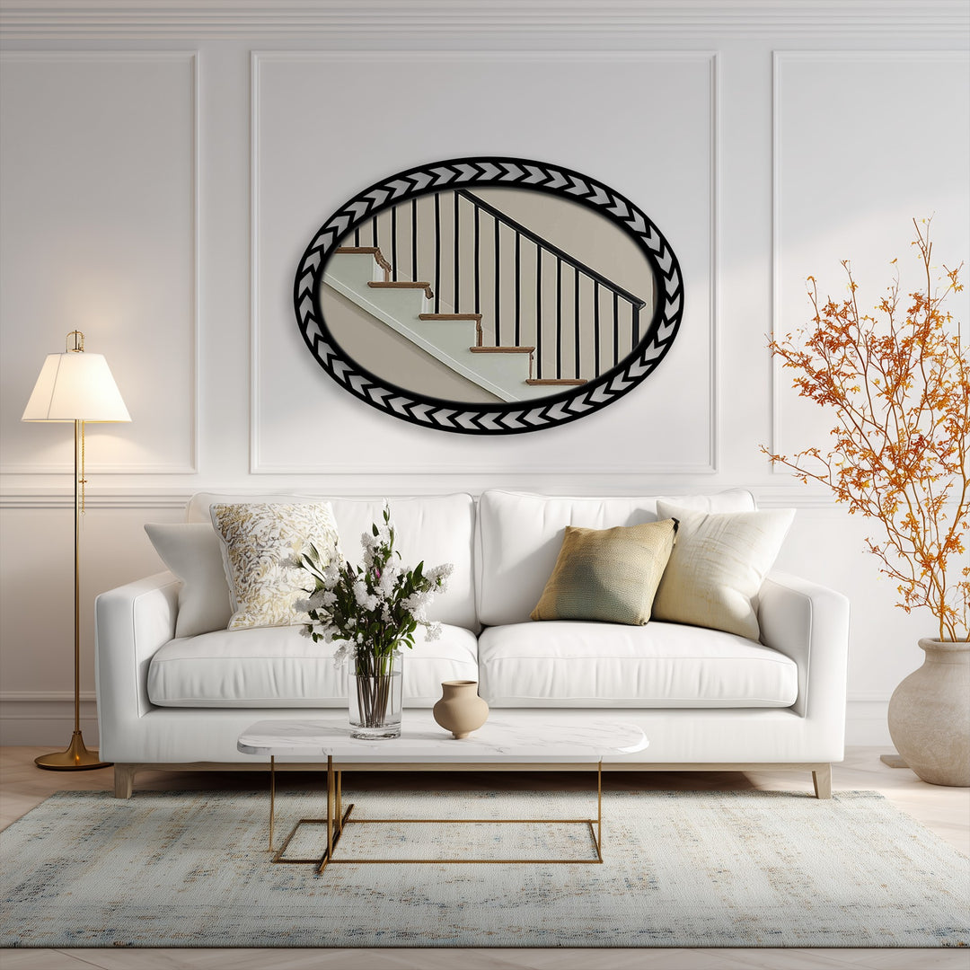 Realistic reflection in the geometric chevron edge oval floor mirror shows the fine detail of a staircase, enhancing the stained glass wall mirror aesthetic.