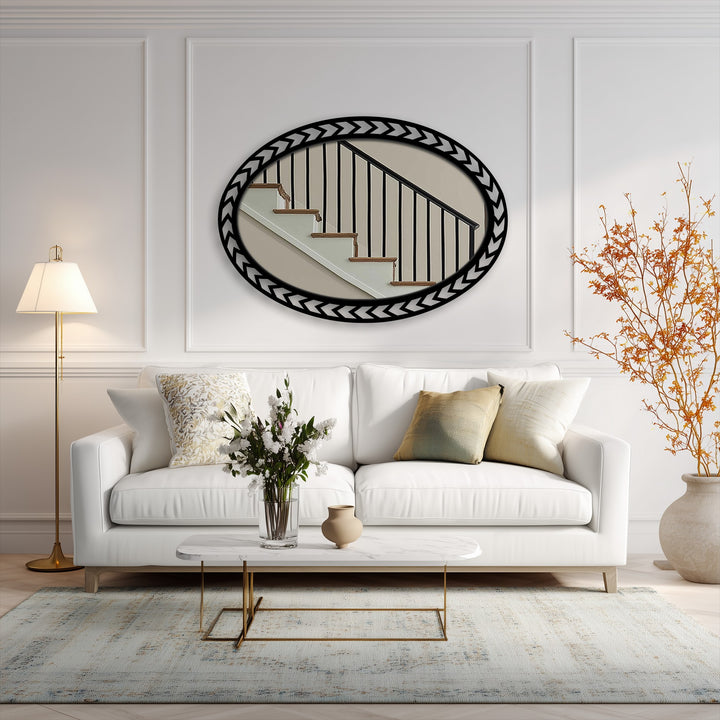 Realistic reflection in the geometric chevron edge oval floor mirror shows the fine detail of a staircase, enhancing the stained glass wall mirror aesthetic.