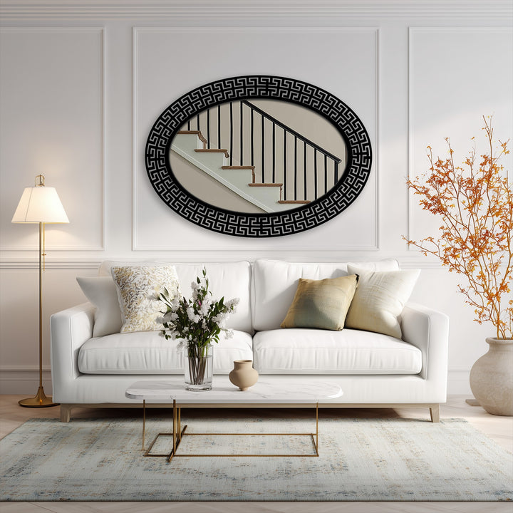 Horizontally oriented, oval-shaped modern mirror showcases a decorative Greek key patterned frame.