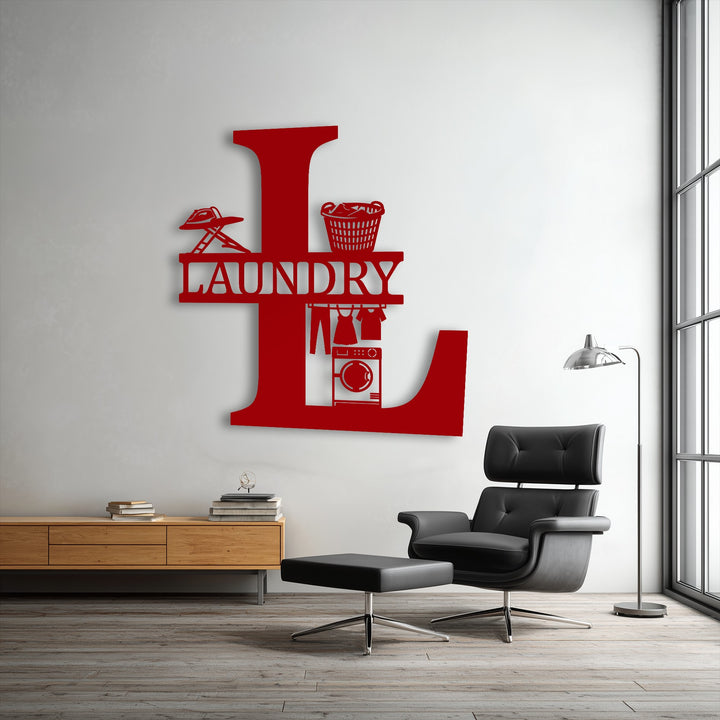 Negative space of the white wall defines a bold red 'L' custom initial unique metal wall art, revealing detailed laundry designs within its form.