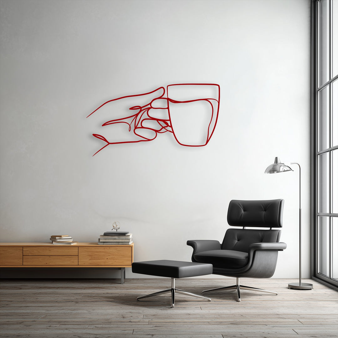 The darkest area reveals a sophisticated black leather armchair and ottoman below minimalist hand holding cup line art metal wall decor.