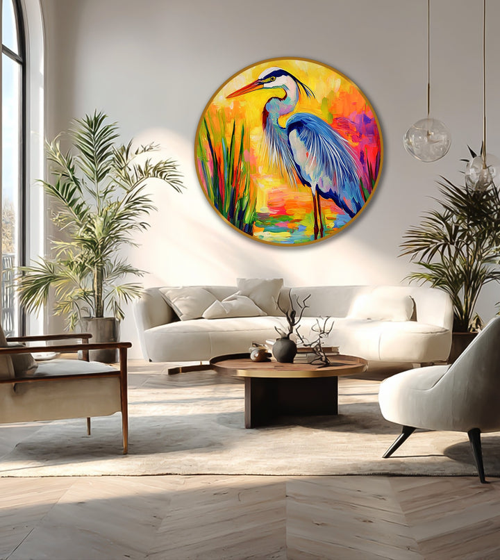 Warm color temperature radiates from this modern oil painting art featuring a round canvas with a vibrant heron in a marsh setting with rich, saturated colors.