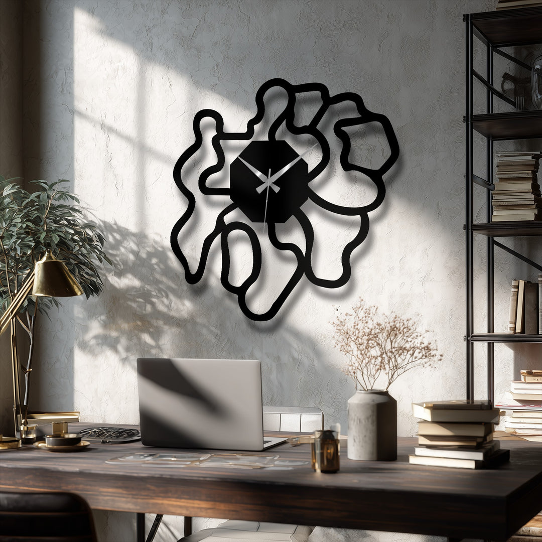 Stillness captures the bold, geometric black shape of a modern abstract organic metal wall clock, creating a compelling, artistic display of unique metal wall art against the textured wall.