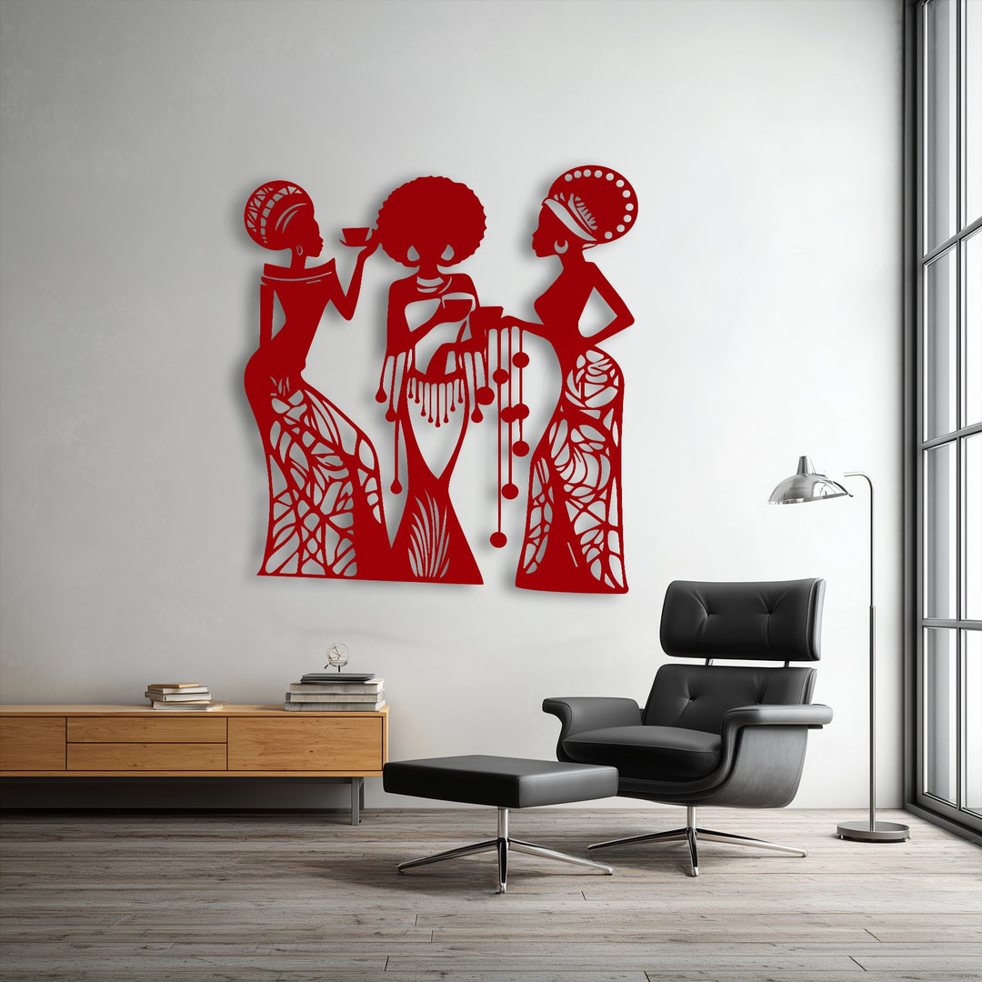 Striking red metal artwork depicting three elegant female silhouettes enriches a crisp white wall in a contemporary setting.