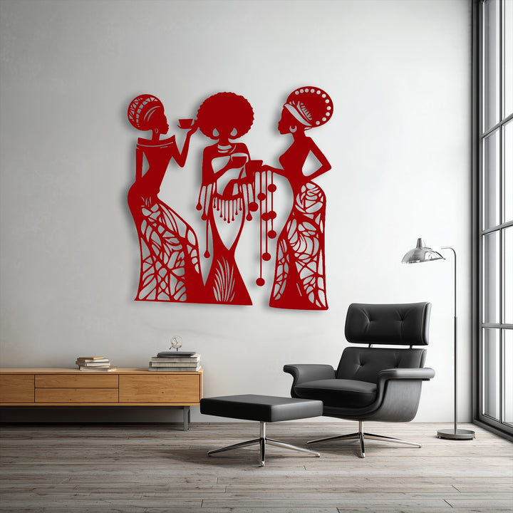 Striking red metal artwork depicting three elegant female silhouettes enriches a crisp white wall in a contemporary setting.