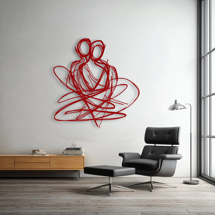 Bold red decorative metal art, an abstract couple in an eternal embrace, offers a vibrant focal point on a white wall.