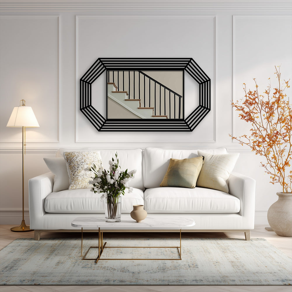 Against the bright white wall, the octagonal mirror for wall decor displays a staircase scene, offering a contrasting focal point within the minimalist setting.