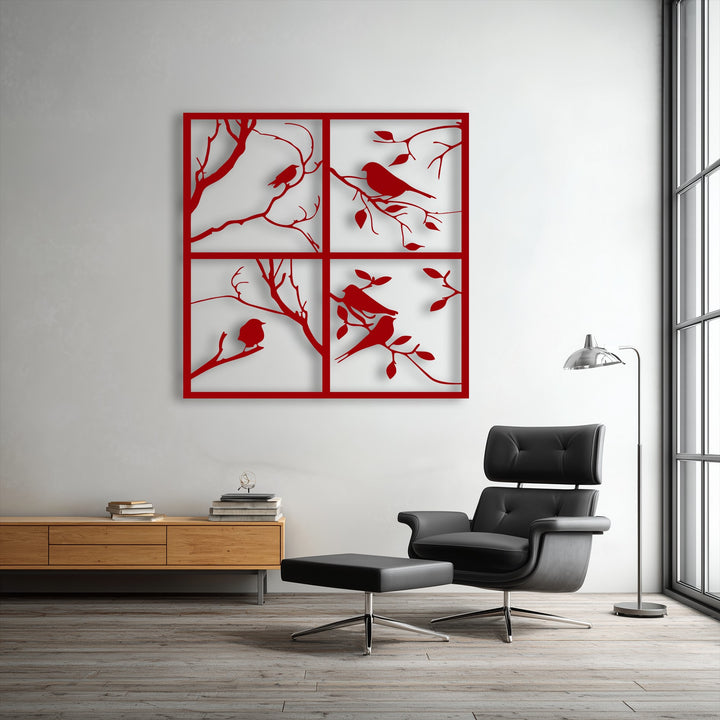 This square metal artwork presents four vertically and horizontally aligned rectangular panels, each illustrating bird silhouettes on tree branches.