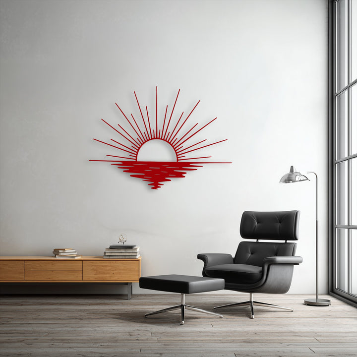 The vibrant red sun rays and ocean reflection decorative metal art creates a striking color contrast against the crisp white wall.