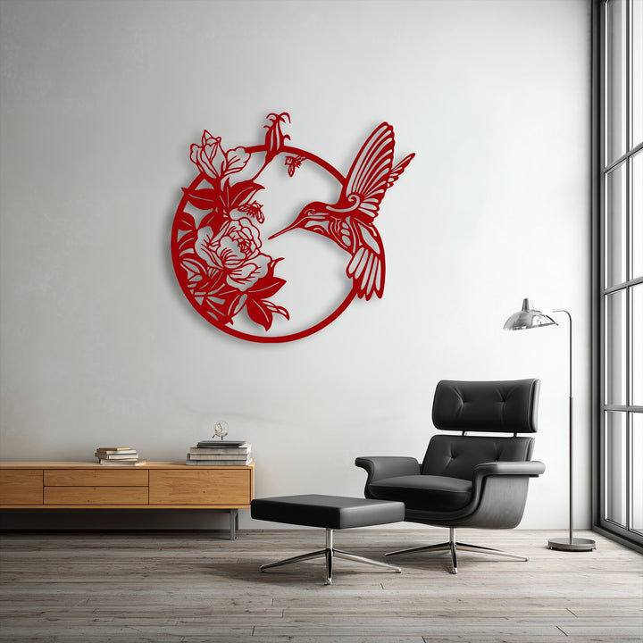 The image showcases the intense color saturation of the vibrant red hummingbird and blooming flowers decorative metal art.