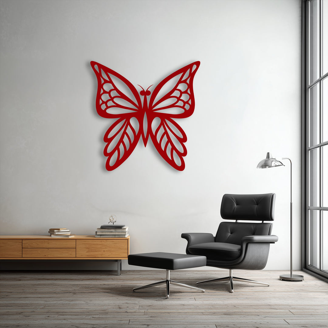 A horizontally oriented unique metal wall art butterfly silhouette with an intricate cutout shape adorns a white wall.