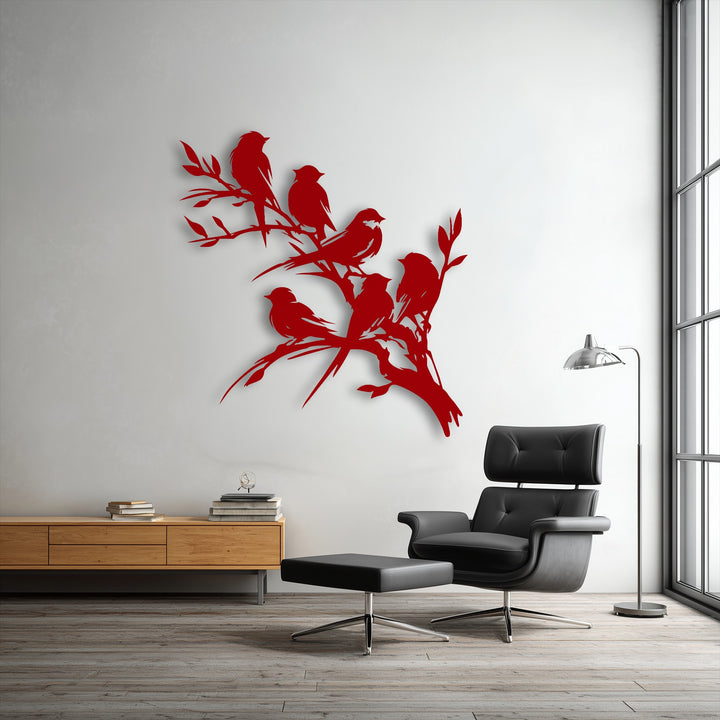 The fluid lines of this metal artwork depict birds gracefully perched and taking flight on a branch, creating a vibrant sense of motion.