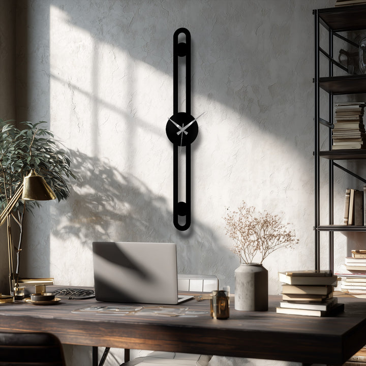Featuring a matte black finish, this minimalist metal wall clock showcases unique metal wall art through its modern slim line design.