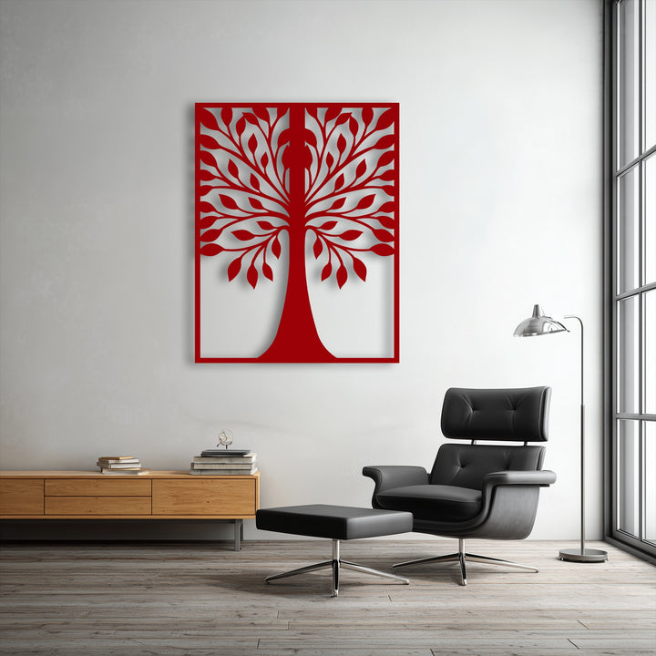 The elegant black leather armchair and ottoman in the foreground complement the striking tree silhouette decorative metal art.