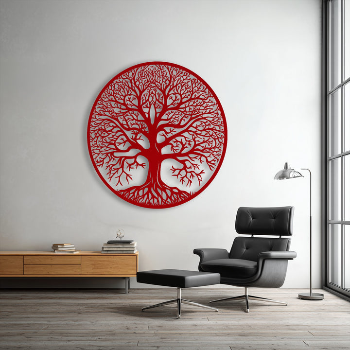 Soft black leather of the armchair and ottoman contrasts with the intricate red Tree of Life decorative metal art.