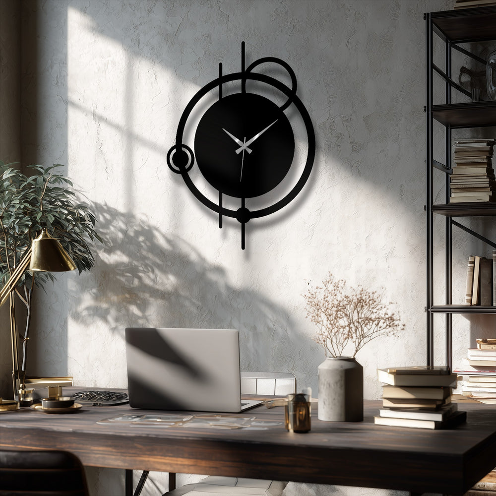 Warm light illuminates the decorative metal art of this modern abstract orbit wall clock, casting cool shadows on the textured wall behind.