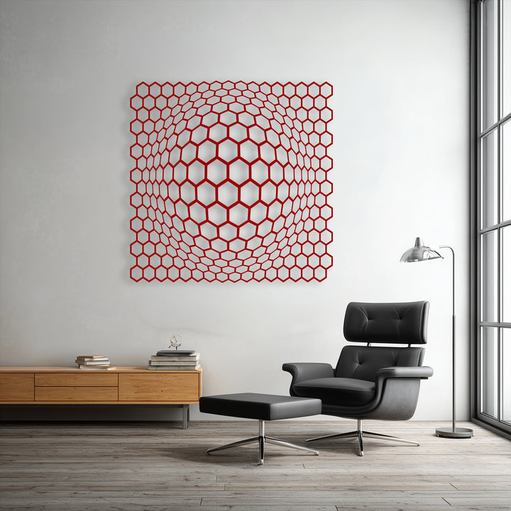 Striking color contrast highlights a unique metal wall art piece, featuring red geometric hexagons creating a mesmerizing 3D depth illusion on a crisp white wall.