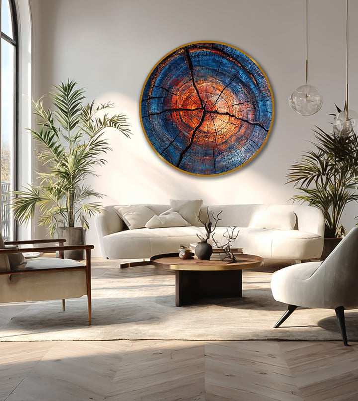 Negative space draws the eye around the striking round oil painting home decor, emphasizing the fiery orange and cool blue tones of the abstract wood ring.