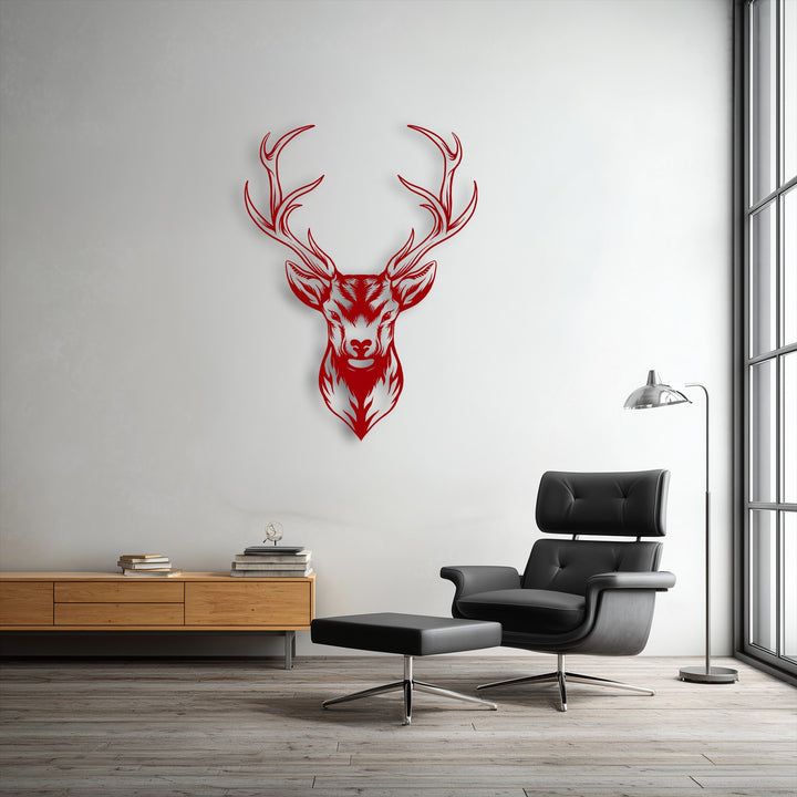 A striking red decorative metal art deer head with majestic antlers serves as the central focal point in a modern room.