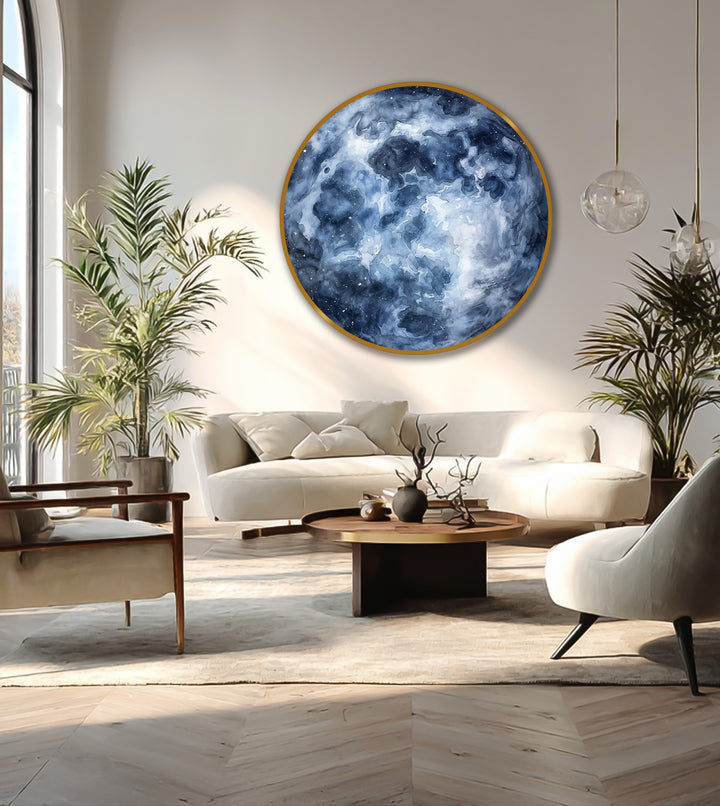 Foreground herringbone floorboards complement the round, deep blue abstract nebula clouds of the oil painting art prints hanging above the neutral living room.