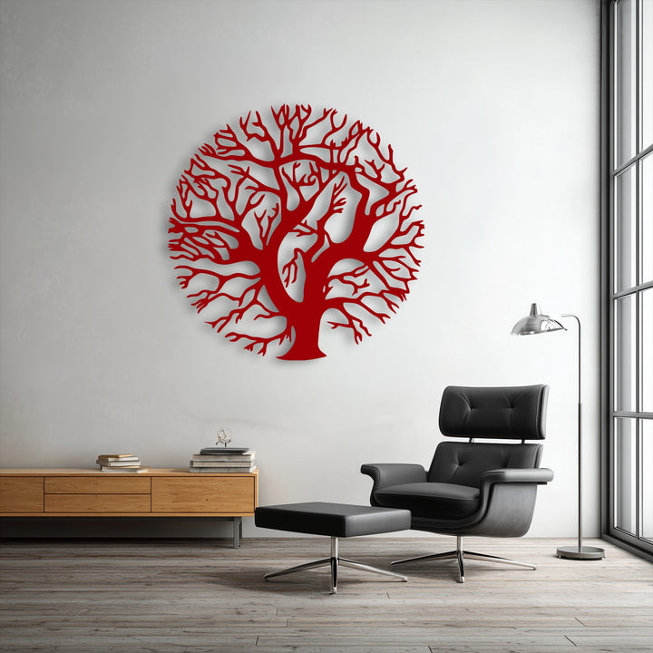 Focusing on the brightest area, a pristine white wall beautifully displays a vibrant red round nature silhouette Tree of Life metal wall decor.