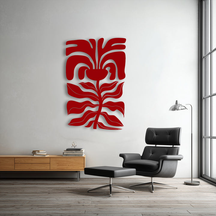 The visual rhythm of the red abstract floral face metal artwork, with its flowing botanical lines, creates dynamic movement in the modern space.