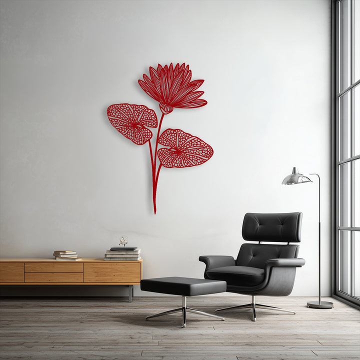 Negative space brilliantly outlines a detailed red lotus bloom and leaves, creating elegant botanical metal wall decor on a bright wall.