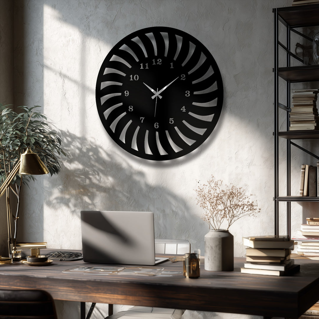 Striking color contrast is evident with a black radial pattern metal wall decor clock sharply defined against the textured, sunlit white wall.