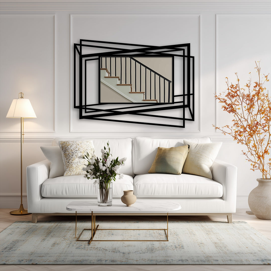 The abstract metal art for wall features overlapping metal lines forming organic shapes, creating a geometric frame around a stairwell scene.