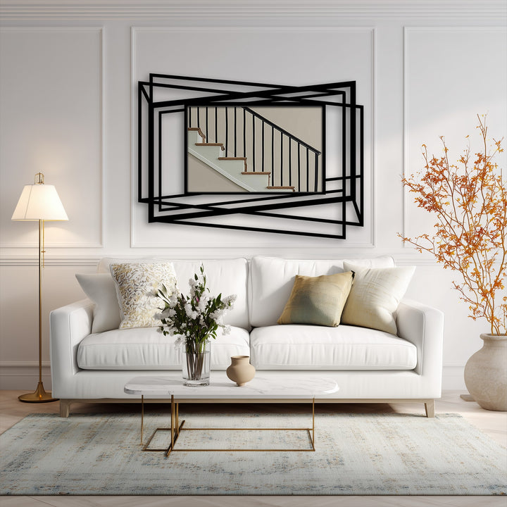The abstract metal art for wall features overlapping metal lines forming organic shapes, creating a geometric frame around a stairwell scene.