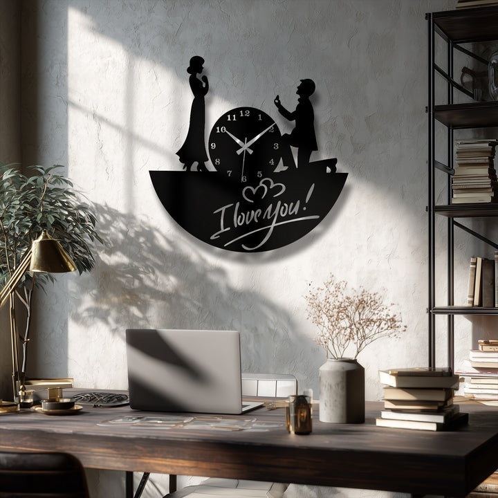 Subtle shadows soften the metal artwork of a love proposal metal wall clock, depicting a romantic couple in silhouette with elegant hands.