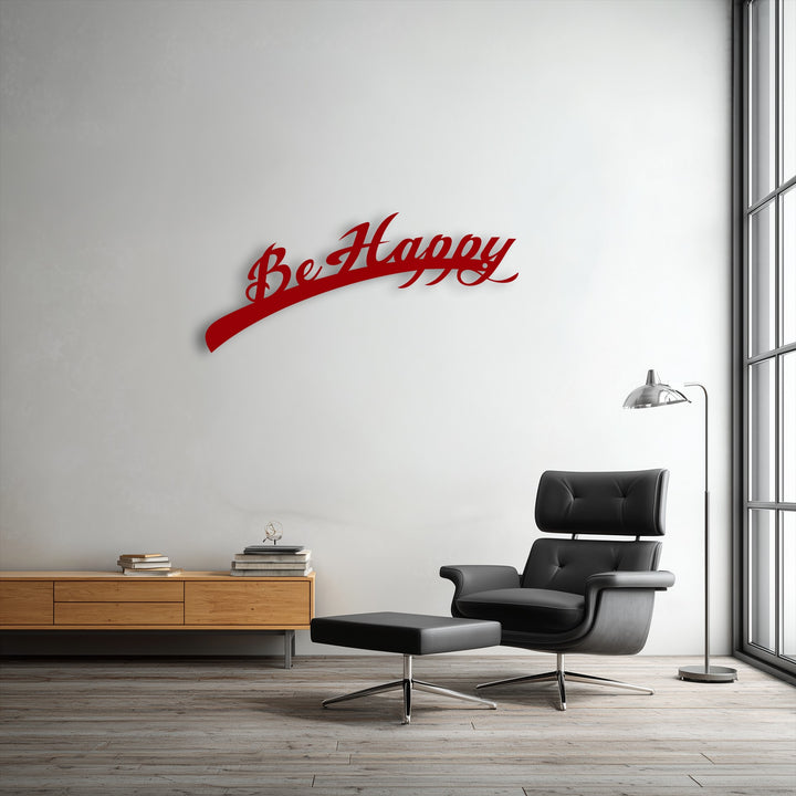 The plush black leather armchair and ottoman provide inviting comfort below the inspiring 'Be Happy' script metal decoration wall art.