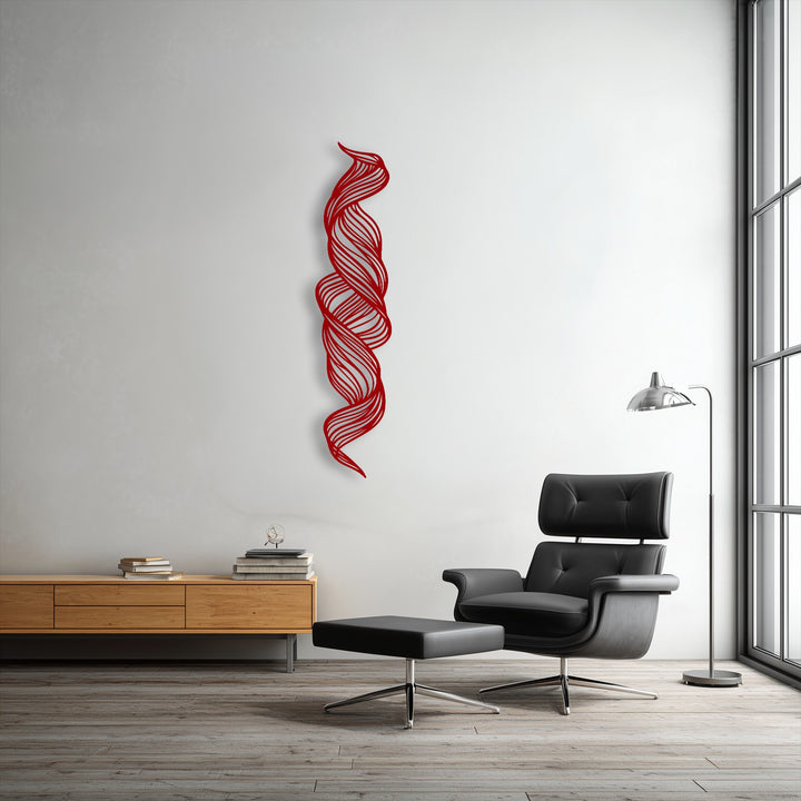 The darkest area in the room, a black leather armchair and ottoman, complements the unique metal wall art featuring a twisted flow abstract design.