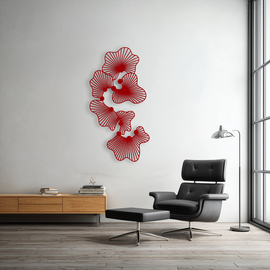 The vibrant red abstract floral metal artwork, with its modern line flower design, is the focal point on the clean white wall.