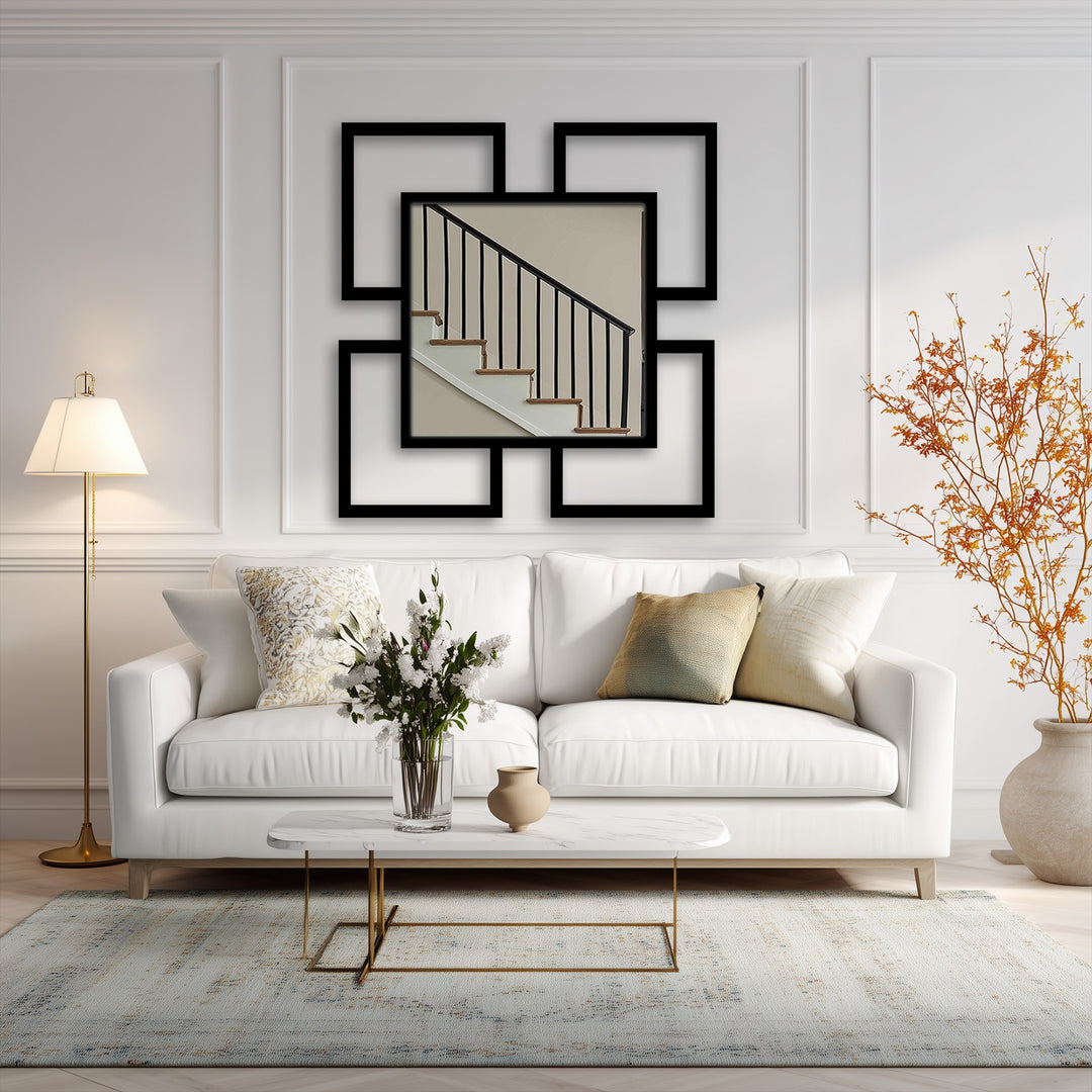Reflecting a neutral-toned stairwell, the central modern wall mirrors art piece features four surrounding geometric square frames, serving as a bold, contemporary focal point.