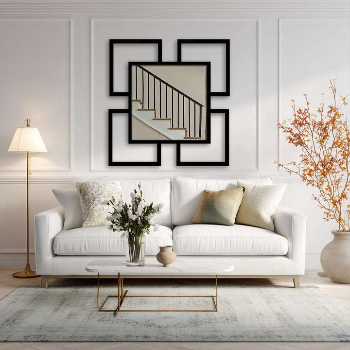 Reflecting a neutral-toned stairwell, the central modern wall mirrors art piece features four surrounding geometric square frames, serving as a bold, contemporary focal point.