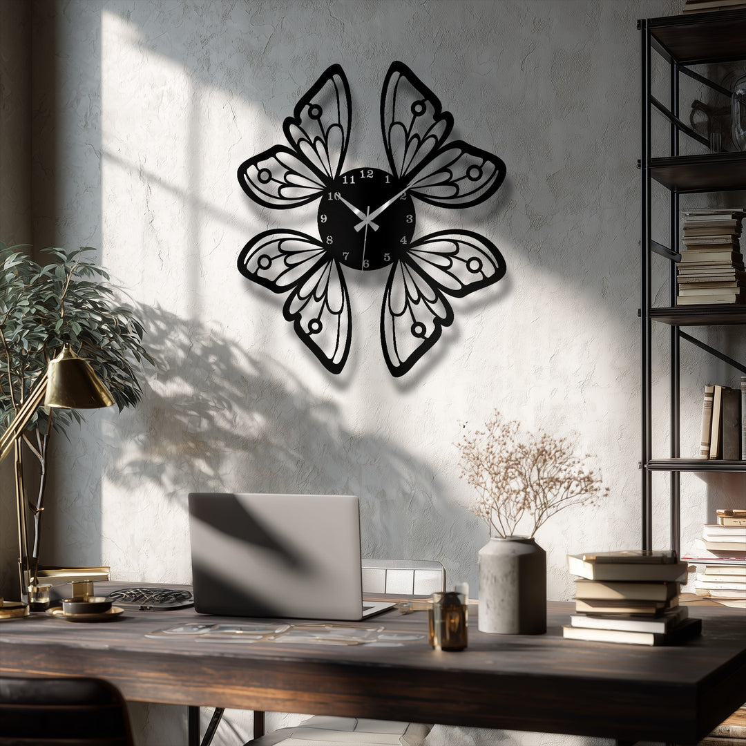 A dark wooden desk holds a silver laptop, a bronze lamp, coffee cup, books, and dried flowers, complementing the elegant decoration wall art.
