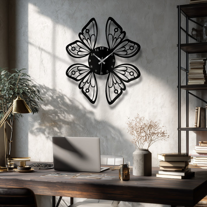 A dark wooden desk holds a silver laptop, a bronze lamp, coffee cup, books, and dried flowers, complementing the elegant decoration wall art.