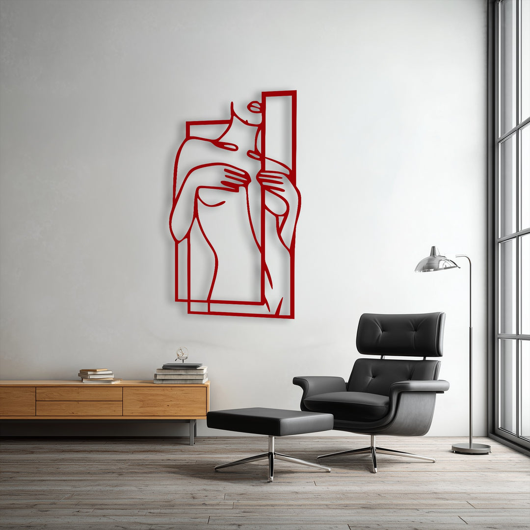 The plush black leather armchair and ottoman provide a soft comfort contrasting with the striking minimalist metal wall decor.
