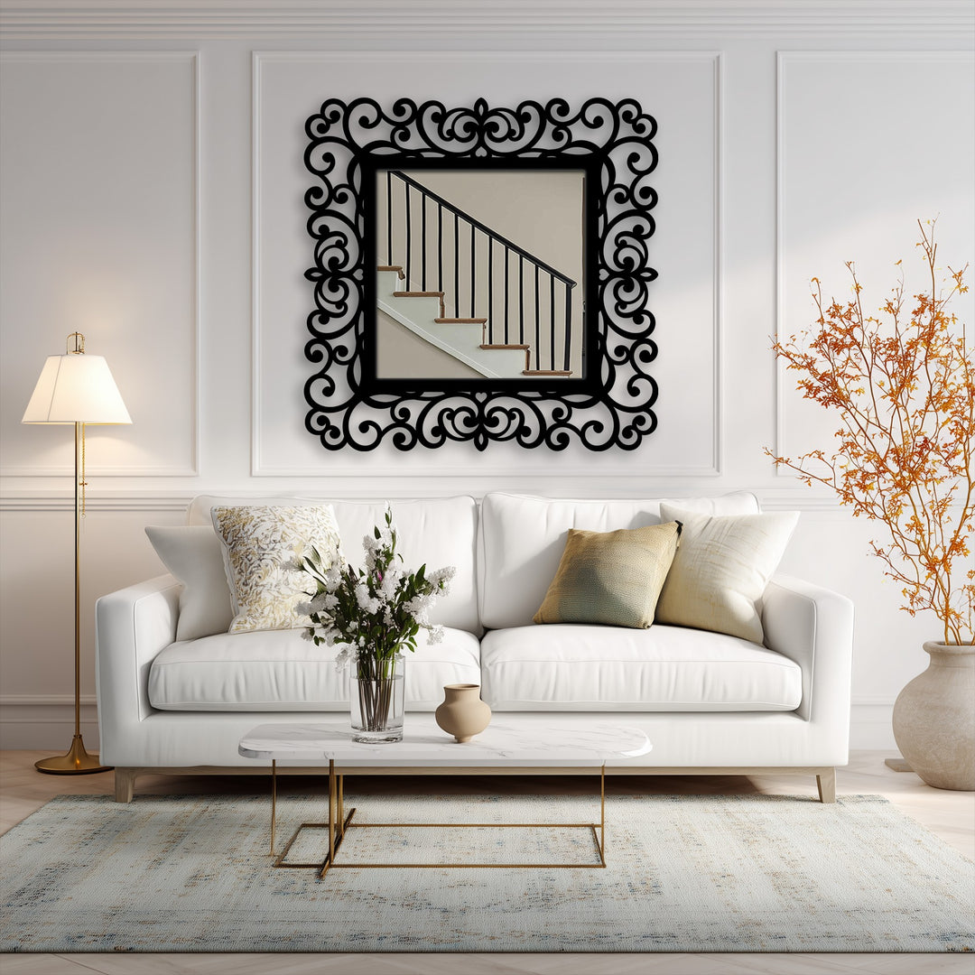 The darkest area defines the ornate scrollwork on the black metal artwork, accentuating the frame of this modern wall mirrors reflecting an interior staircase.
